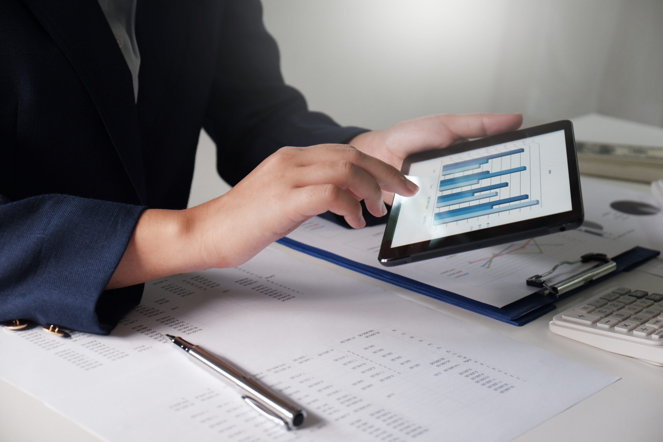 Women working in office. financial analysis with charts on pad f